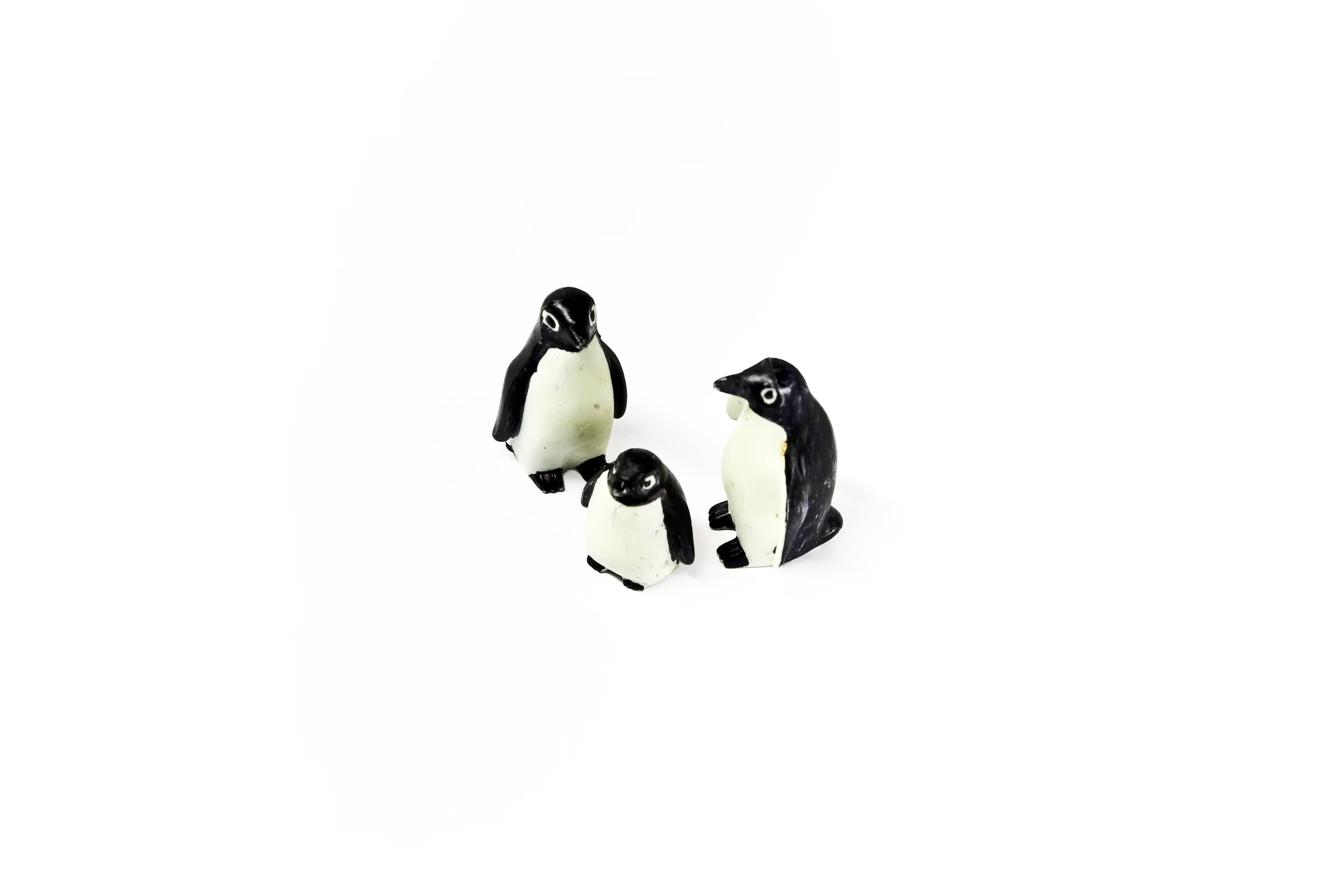 Trio of penguin figurines